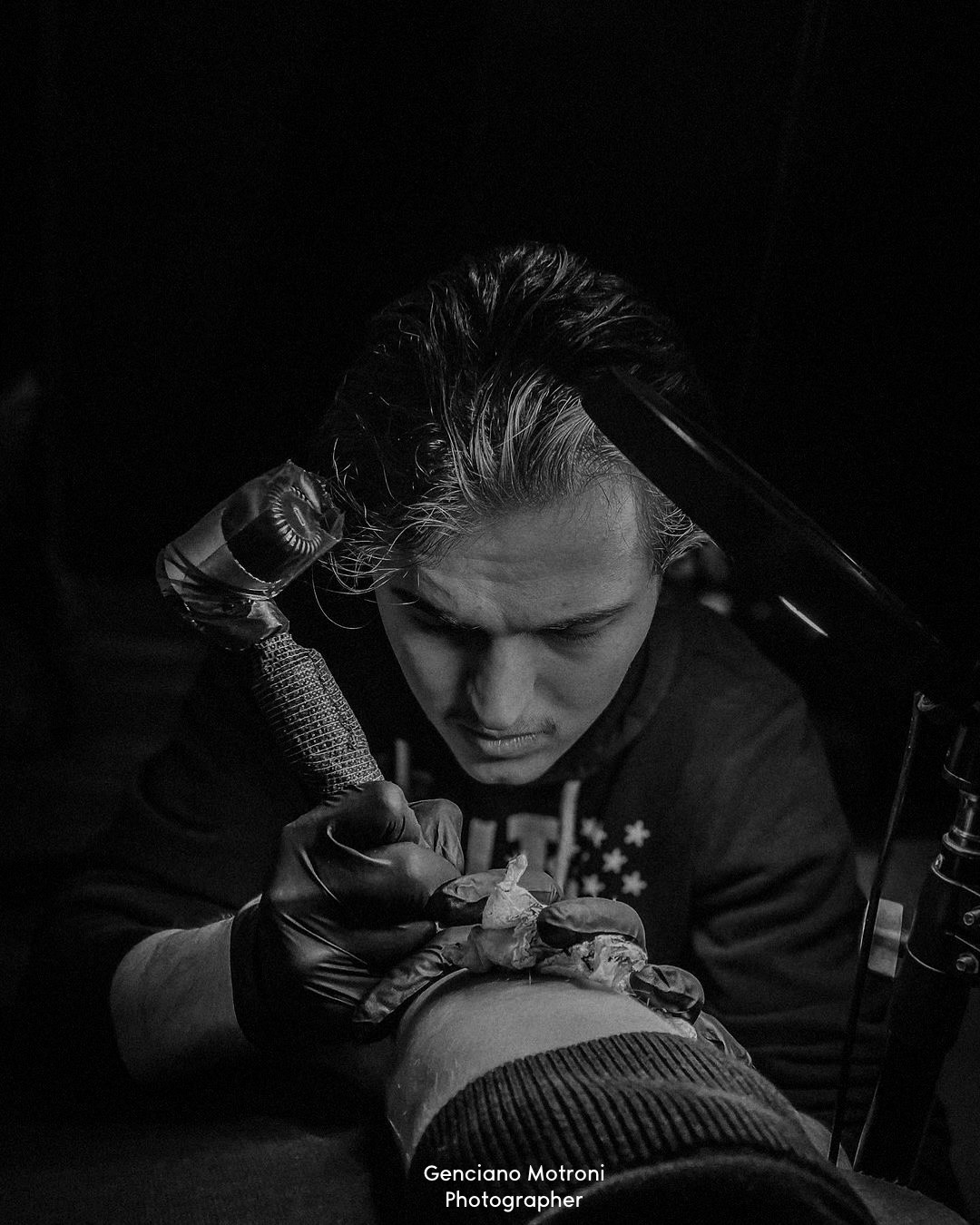 A Paradox artist tattooing a client's arm