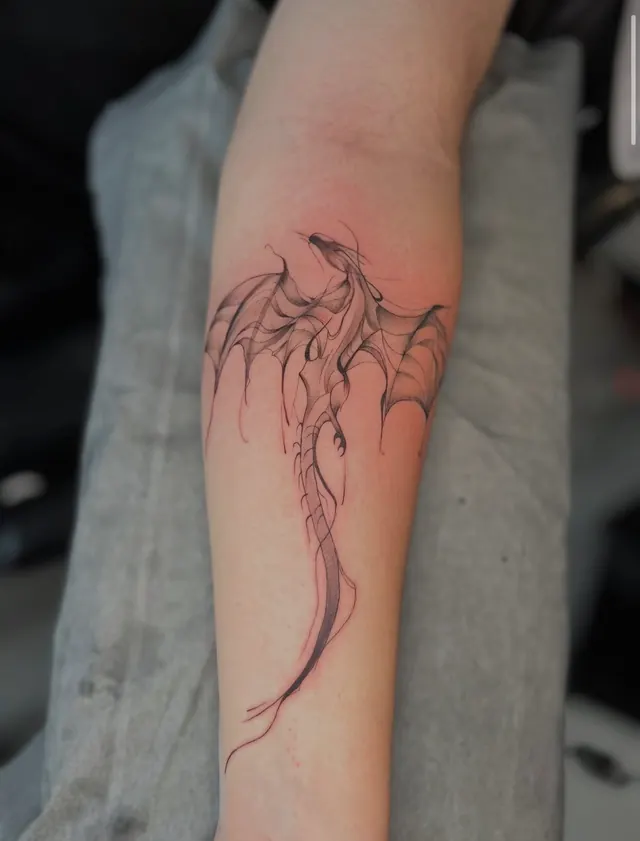 Fine line dragon on the forearm